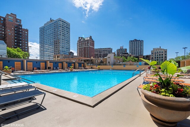 pool featuring a view of city and a patio area