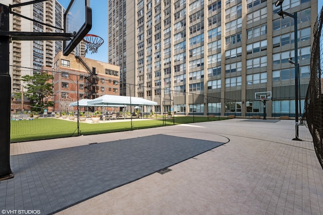 exterior space featuring community basketball court and fence