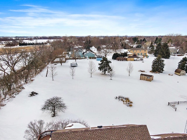 snowy aerial view featuring a residential view