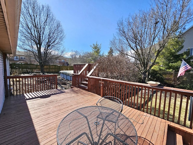 wooden deck featuring a fenced backyard and outdoor dining area