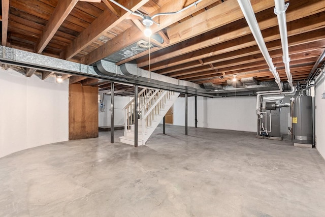 unfinished below grade area with stairs and gas water heater