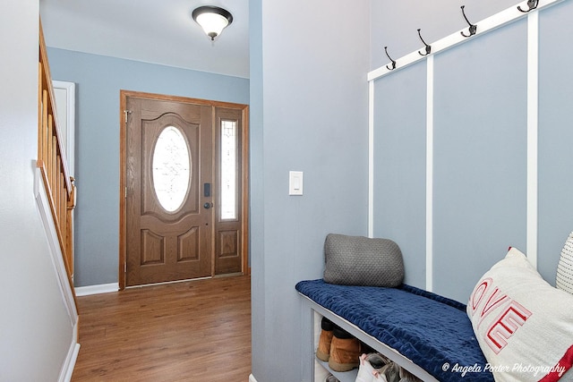 entrance foyer with stairway, light wood-type flooring, and baseboards