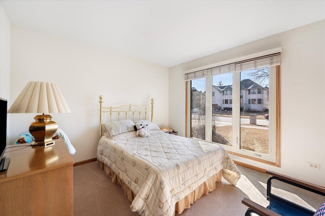 bedroom with carpet and baseboards