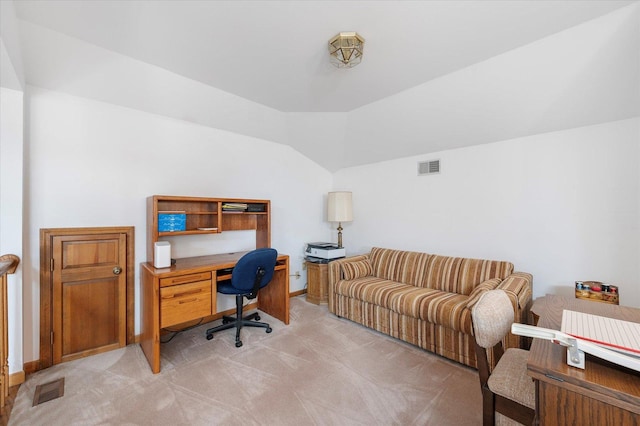 office space featuring visible vents, vaulted ceiling, light carpet, and baseboards