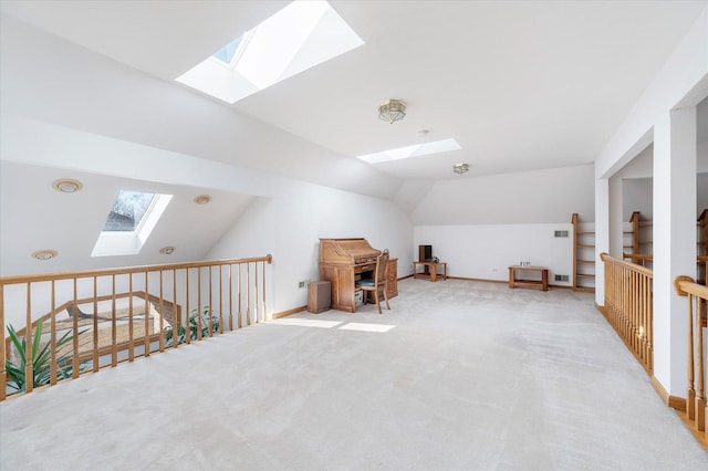 bonus room featuring lofted ceiling with skylight, carpet, and baseboards