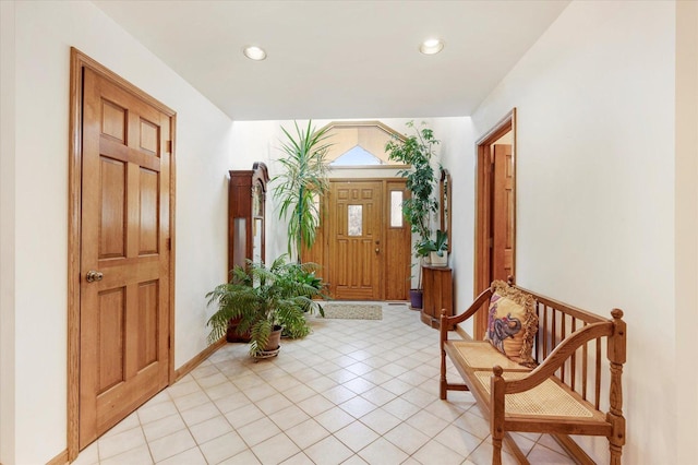 entrance foyer featuring baseboards, light tile patterned flooring, and recessed lighting