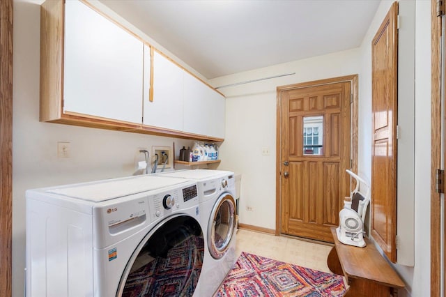 clothes washing area with light floors, washing machine and clothes dryer, cabinet space, and baseboards