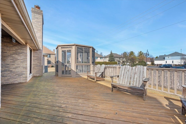 wooden deck with a sunroom