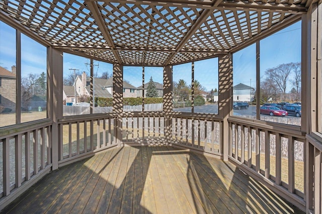 wooden terrace with a residential view and a pergola