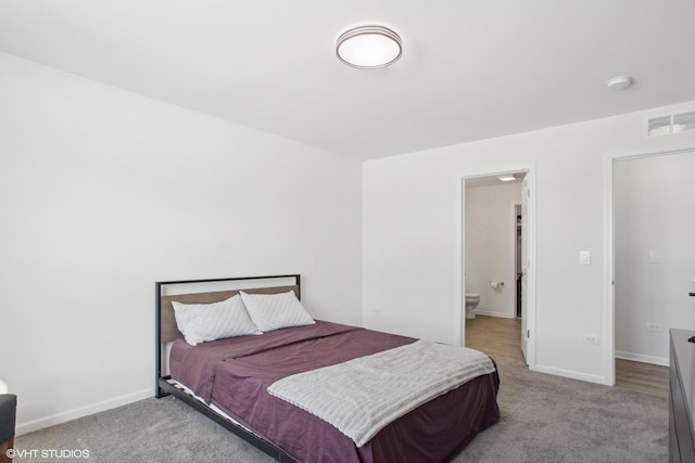 bedroom featuring carpet floors, baseboards, visible vents, and ensuite bathroom