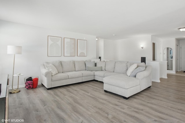 living room featuring light wood-type flooring and baseboards