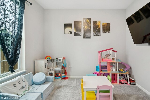 playroom featuring carpet floors and baseboards