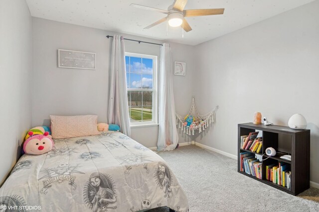 carpeted bedroom featuring a ceiling fan and baseboards