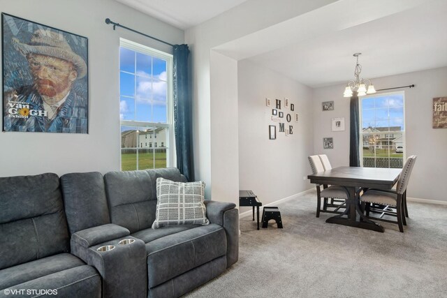 carpeted living room with baseboards and an inviting chandelier