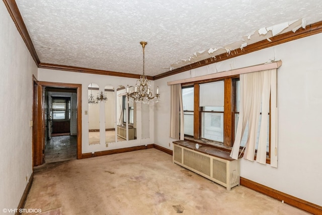 unfurnished dining area featuring carpet, crown molding, radiator, a textured ceiling, and a chandelier