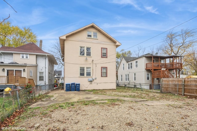 rear view of property featuring a fenced backyard and a patio