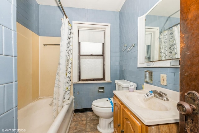 bathroom with toilet, shower / tub combo with curtain, tile walls, and vanity