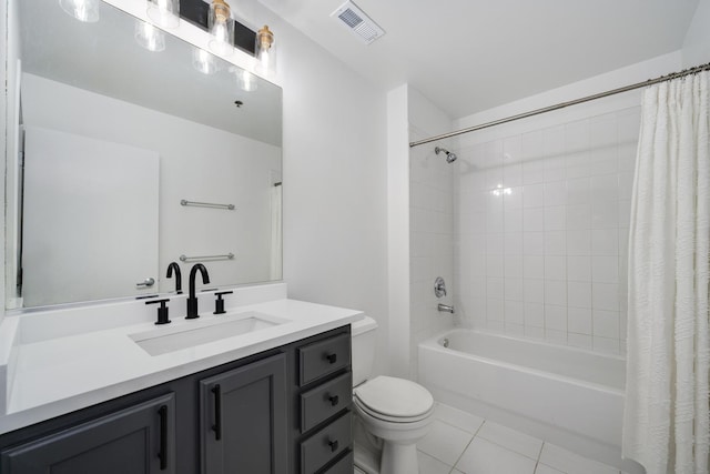 bathroom featuring toilet, vanity, visible vents, tile patterned floors, and shower / bath combination with curtain