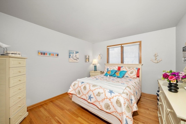 bedroom featuring light wood-type flooring and baseboards