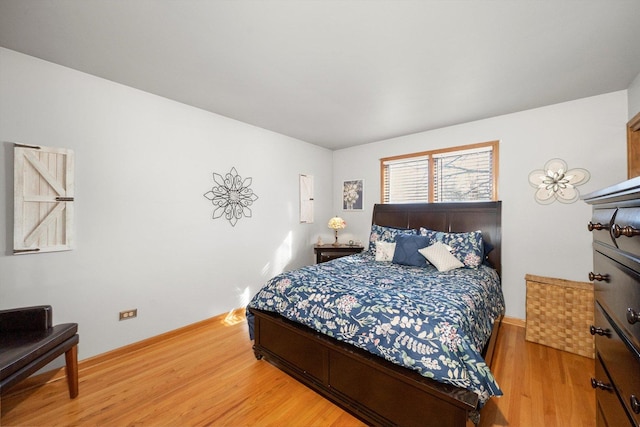 bedroom with light wood-type flooring and baseboards