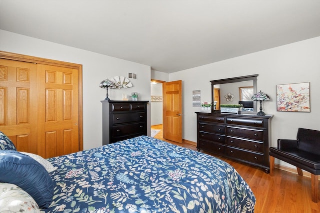 bedroom featuring visible vents and wood finished floors