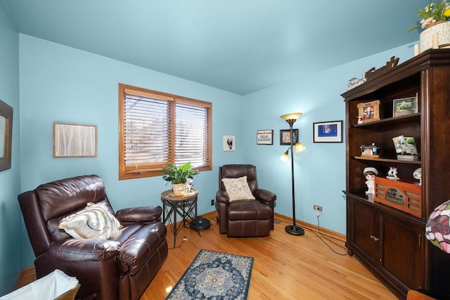 sitting room featuring baseboards and light wood-style flooring