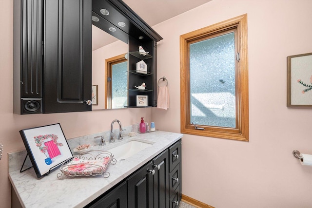 bathroom featuring baseboards and vanity