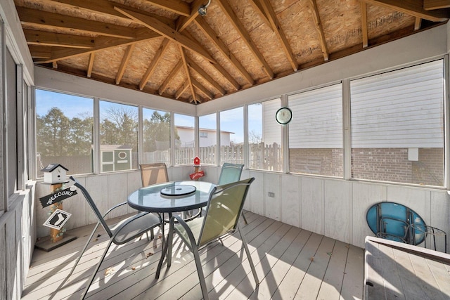 sunroom featuring vaulted ceiling