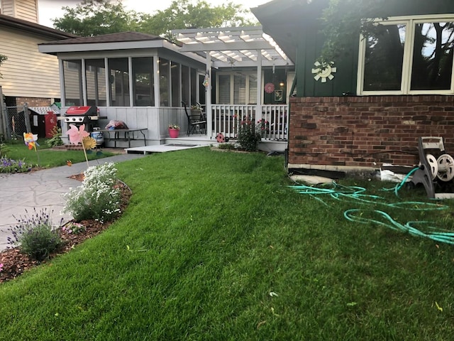 view of yard with a patio and a sunroom