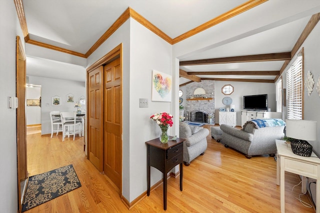 corridor with lofted ceiling with beams, light wood-style floors, baseboards, and ornamental molding