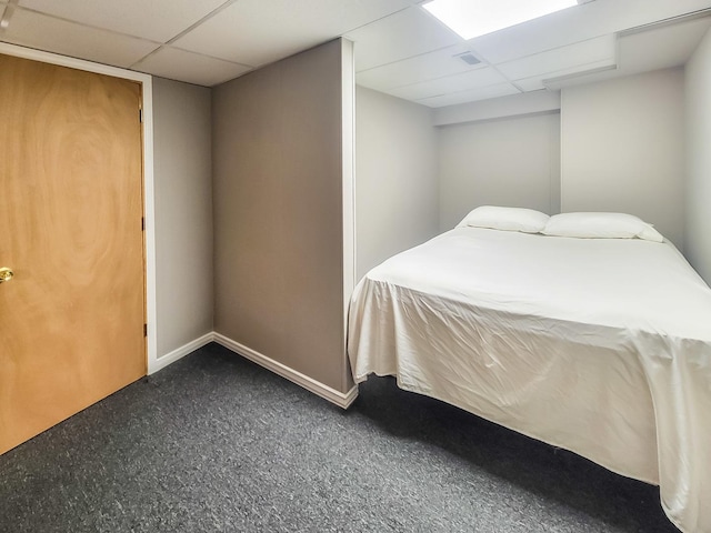 bedroom with visible vents, baseboards, and a drop ceiling