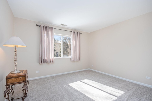 unfurnished room featuring carpet flooring, visible vents, and baseboards