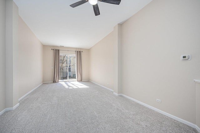 empty room featuring baseboards, ceiling fan, and light colored carpet