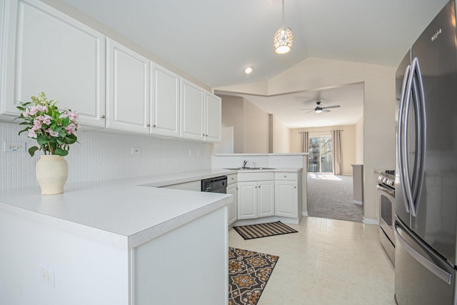 kitchen featuring decorative light fixtures, light countertops, appliances with stainless steel finishes, white cabinets, and a peninsula