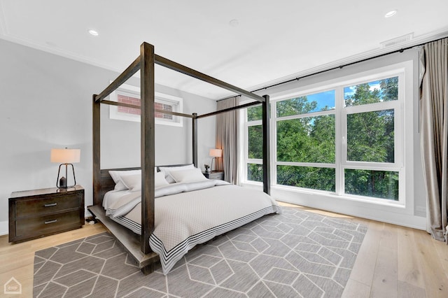 bedroom with light wood finished floors and recessed lighting