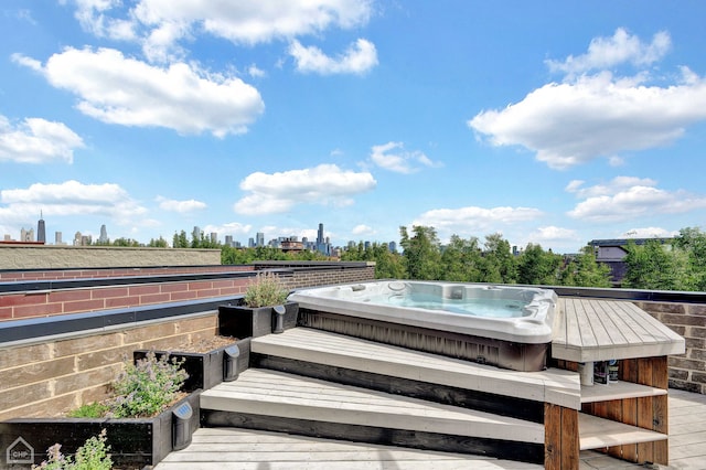 exterior space featuring a view of city and hot tub deck surround