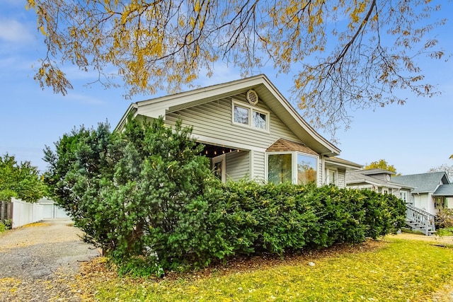 view of home's exterior with a yard and fence