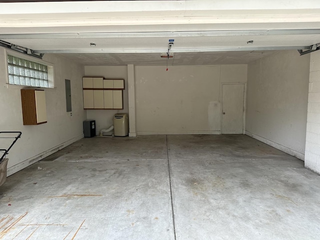 garage featuring electric panel and a garage door opener