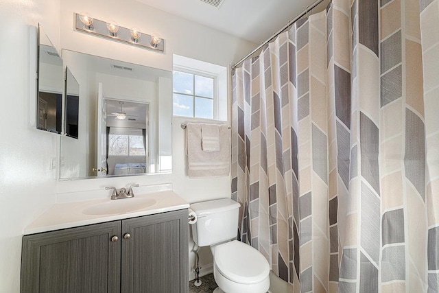 bathroom with toilet, vanity, visible vents, and a shower with curtain