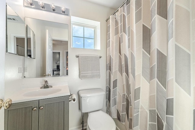 bathroom featuring toilet, a shower with shower curtain, vanity, and visible vents