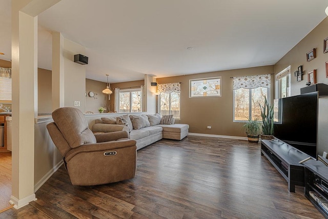 living area with dark wood-style floors and baseboards