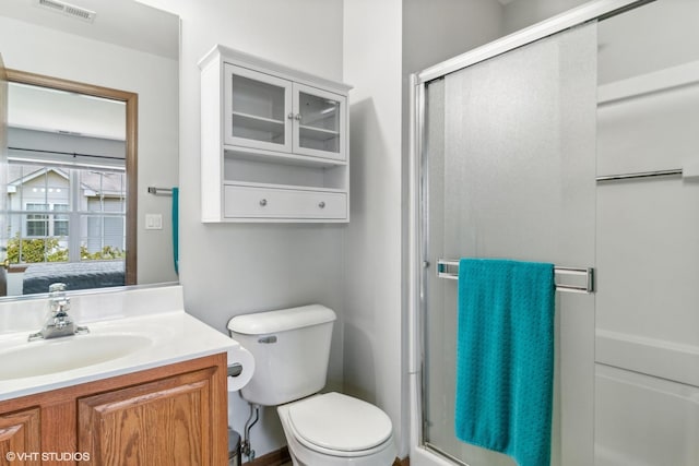 full bathroom featuring visible vents, toilet, a stall shower, and vanity