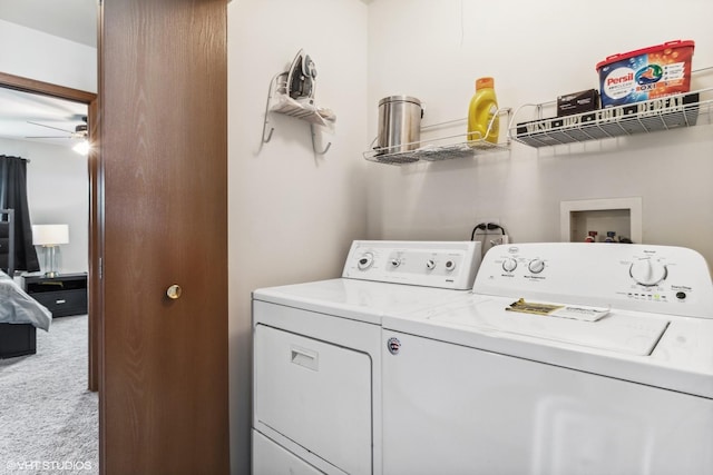 washroom with laundry area, washing machine and dryer, a ceiling fan, and carpet