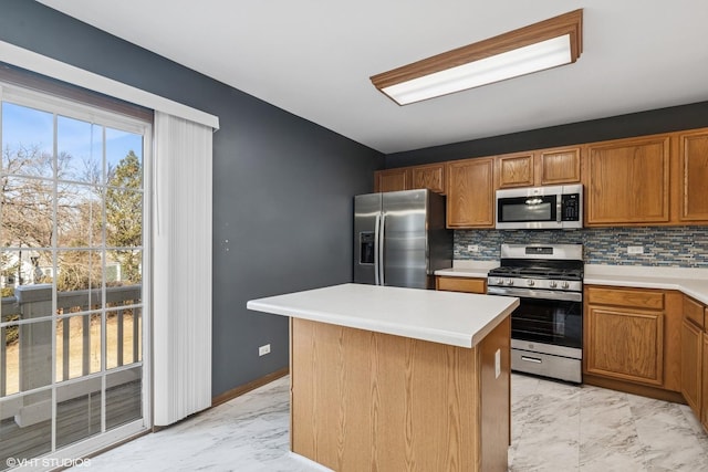 kitchen with tasteful backsplash, marble finish floor, stainless steel appliances, and light countertops