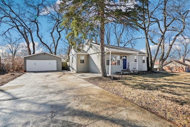 view of front of house featuring covered porch, a front lawn, an outdoor structure, and a detached garage