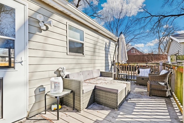 wooden terrace with an outdoor living space