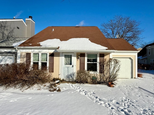 view of front of home featuring a chimney and an attached garage