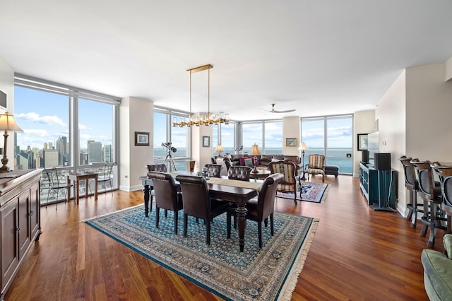 dining area with plenty of natural light, wood finished floors, ceiling fan, and expansive windows