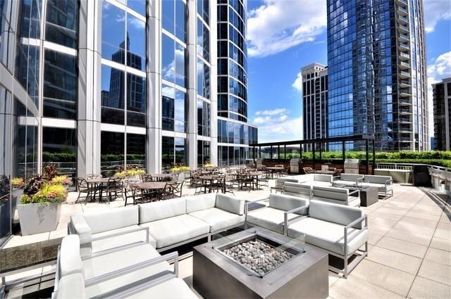 view of patio with a city view and an outdoor living space with a fire pit