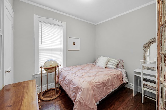 bedroom featuring baseboards, ornamental molding, and dark wood-type flooring